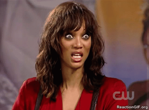 Woman Making Funny Face in Front of CW Sign