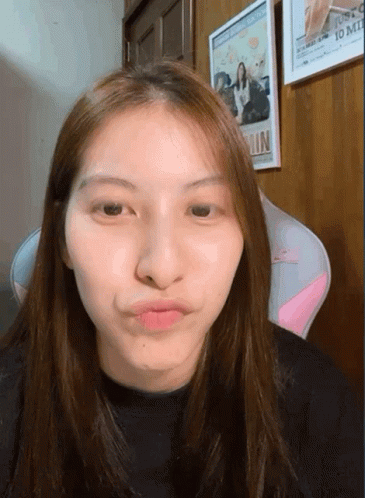 Woman Making Funny Face in Front of Justco 10 Mil Picture