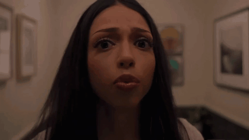 Woman Making Funny Face In Front Of Picture Wall GIF