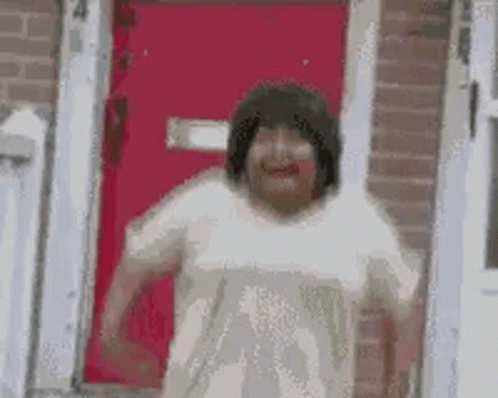 Woman Making Funny Face in Front of Red Door