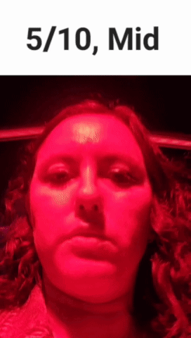 Woman Making Funny Face In Front Of Red Light GIF