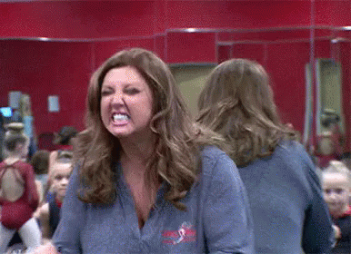 Woman Making Funny Face in Mirror