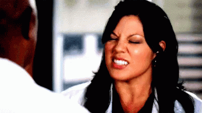 Woman Making Funny Face Talking To Man In Lab Coat GIF