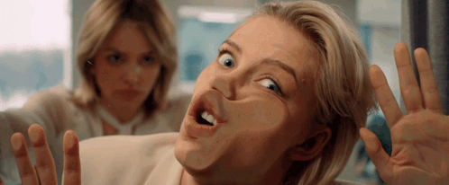 Woman Making Funny Face With Another Behind Her