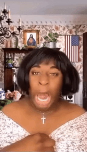 Woman Making Funny Face With Cross Necklace and American Flag
