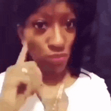 Woman Making Funny Face With Finger to Ear