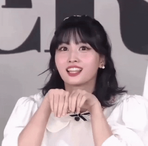 Woman Making Funny Face with Folded Hands