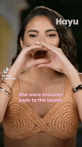 Woman Making Heart with Hands She Wore Shoulder Pads to the Beach