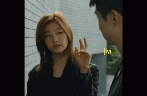 Woman Making OK Sign Next To Man GIF