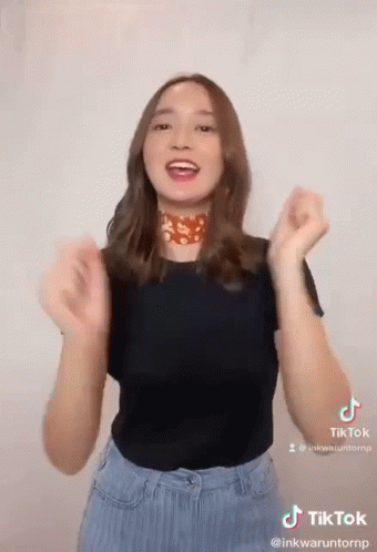 Woman Making TikTok Black Shirt Blue Jeans