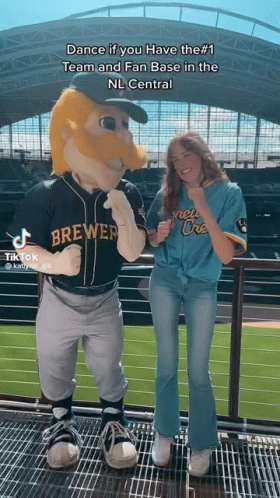 Woman Next to Brewers Mascot on Balcony