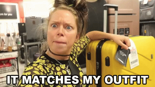 Woman Next to Yellow Suitcase Saying It Matches My Outfit