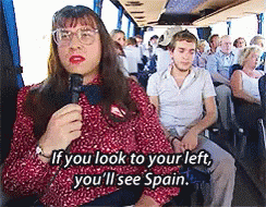 Woman On Bus Talking Into Microphone Saying If You Look To Your Left You'll See Spain GIF