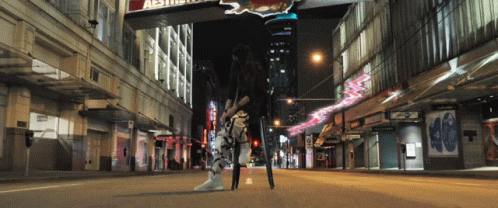 Woman on City Street Under Aesthetic Sign