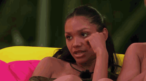 Woman On Couch Hand To Face GIF
