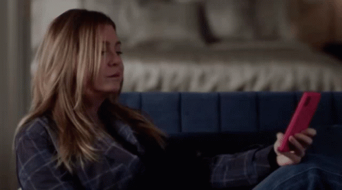 Woman on Couch Looking at Phone