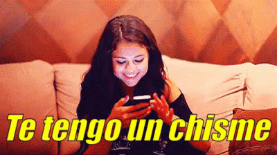 Woman On Couch Looking At Phone Te Tengo Un Chisme GIF