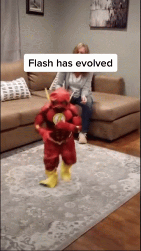 Woman on Couch With Child in Flash Costume