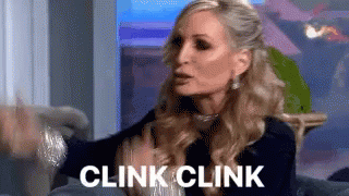 Woman On Couch With Hands Outstretched Saying Clink Clink GIF