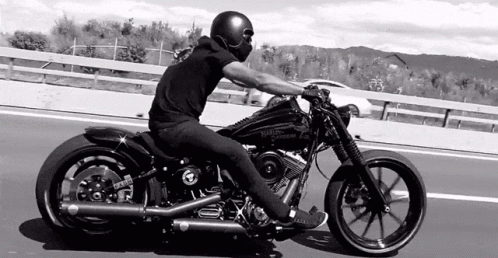 Woman on Motorcycle Next to Standing Woman