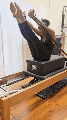 Woman on Pilates Machine Legs Up