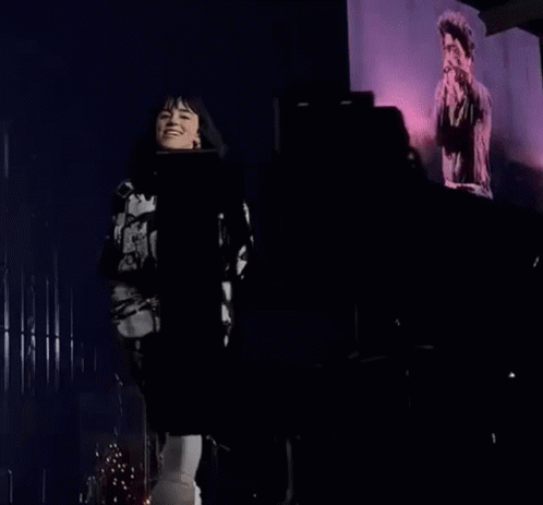 Woman On Stage Holding Microphone Pointing GIF