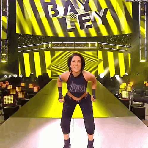Woman on Stage in Front of Bayley Screen