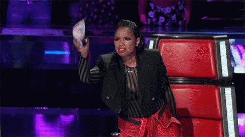 Woman On Stage In Red Chair Holding Microphone GIF
