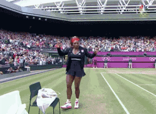 Woman on Tennis Court in Front of London 2012 Stadium