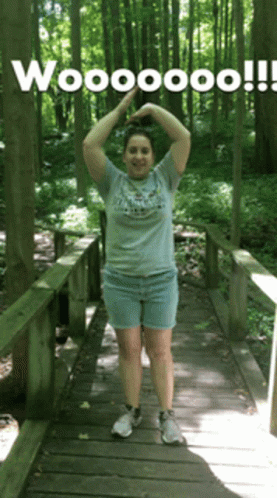 Woman on Wooden Bridge Arms Up Wooooo