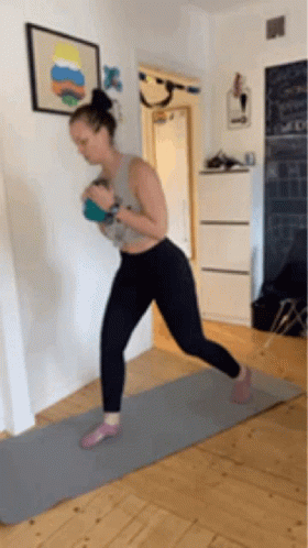 Woman on Yoga Mat Holding Ball