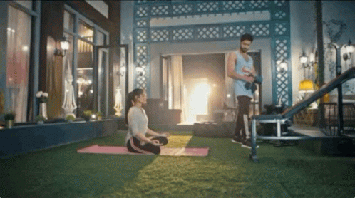Woman on Yoga Mat Man with Dumbbells