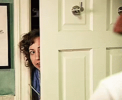 Woman Peeking From Behind Door With Picture GIF