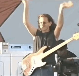 Woman Playing Guitar By Washing Machine GIF