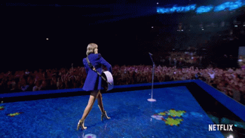 Woman Playing Guitar On Stage With Netflix GIF