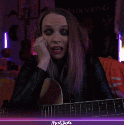 Woman Playing Guitar with Elden Ring Banner