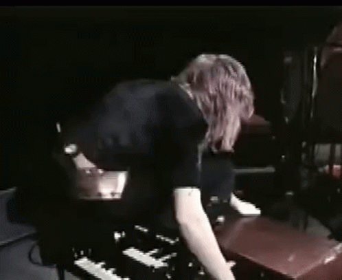 Woman Playing Piano In Dark Room GIF