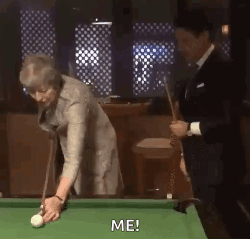 Woman Playing Pool with Man Behind
