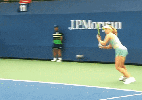 Woman Playing Tennis In Front Of JPMorgan Wall GIF