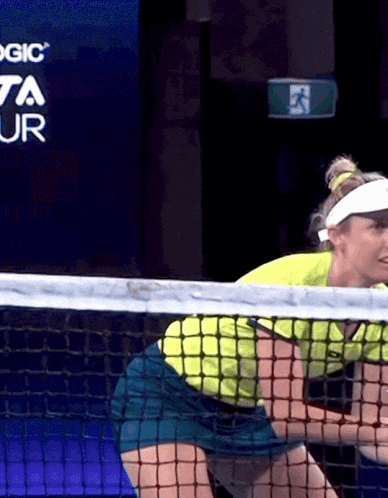 Woman Playing Tennis in Front of Toyota Ad