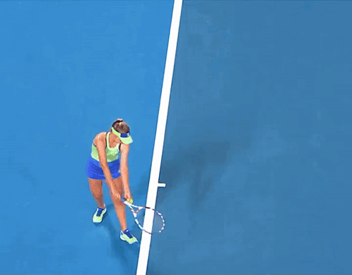 Woman Playing Tennis on Blue Court With Kia Ads