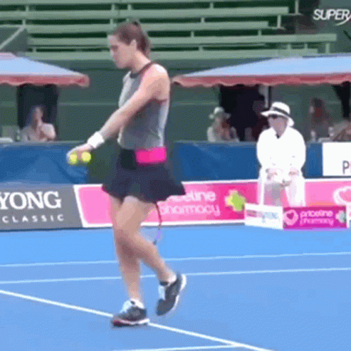 Woman Playing Tennis on Court with Super Yong Classic Sign