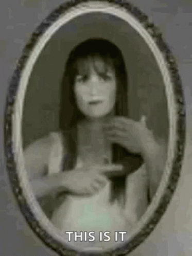 Woman Pointing At Herself In Mirror GIF