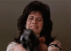 Woman Pointing Gun at Camera While Crying
