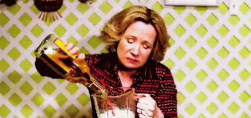 Woman Pouring Alcohol Into Blender GIF