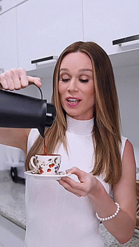 Woman Pouring Coffee from Thermos