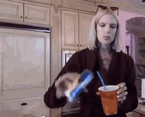 Woman Pouring Soda Into Cup With Straw GIF