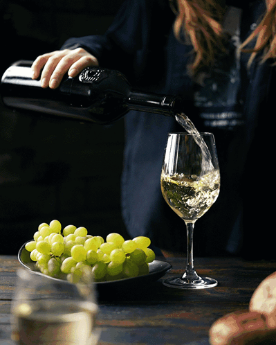 Woman Pouring Wine from S.A. Bottle
