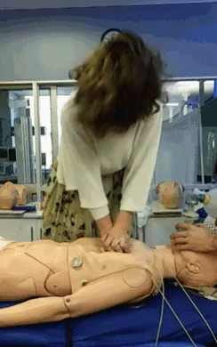 Woman Practicing on Mannequin with Clock