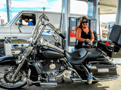 Woman Pumping Gas Into Harley Davidson Motorcycle